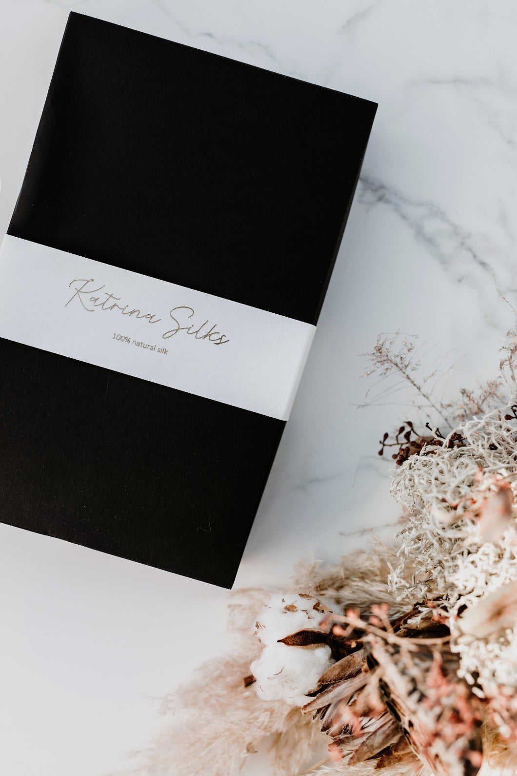 A beautiful black and white Katrina Silks natural silk product gift box