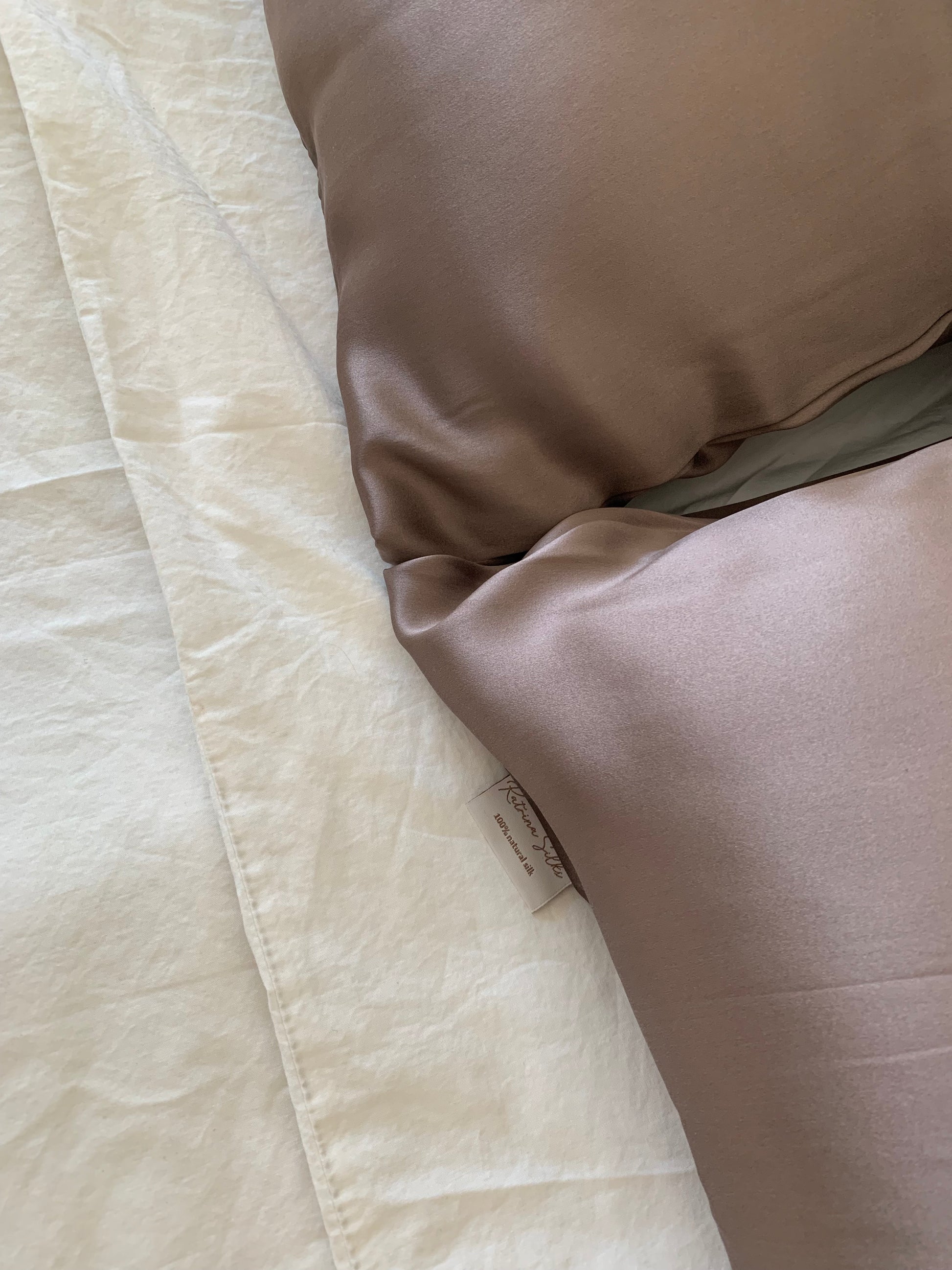 Close-up of two mocha colour silk pillowcases