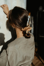 Load image into Gallery viewer, Artist girl with gold silk scrunchie and paint brushes in her hair
