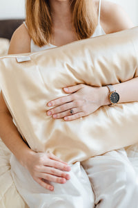 Girl holding natural silk pillowcase Cappuccino Beige